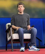 Photograph of OpenAI CEO Sam Altman seated on stage at a TED conference.
