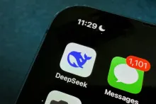 The DeepSeek app icon, showing its blue whale logo, on a smartphone home screen.