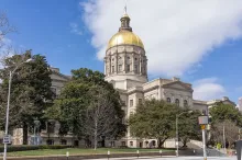 Photograph of the Georgia State Capitol building in Atlanta with its gold dome under a blue sky.