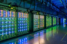 Server racks with colorful status lights inside a Google data center.