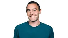 A photograph of Kevin Weil, founder of Warp Sciences and former OpenAI science lead, smiling in a teal shirt.