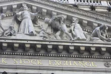 Photograph of the carved stone facade of the New York Stock Exchange building with its gold Stock Exchange lettering.