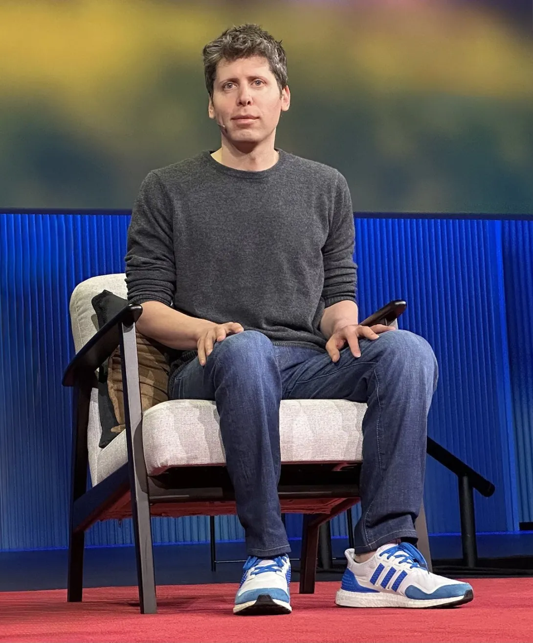 Photograph of OpenAI CEO Sam Altman seated on stage at a TED conference.