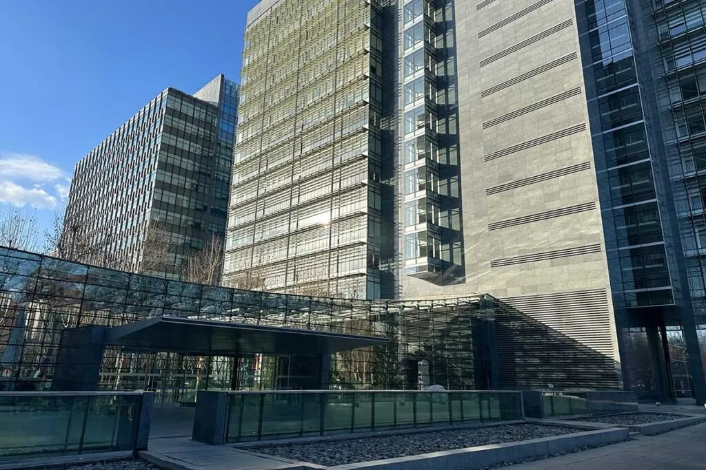 The offices of DeepSeek in Beijing, a modern glass office complex photographed on a clear day.