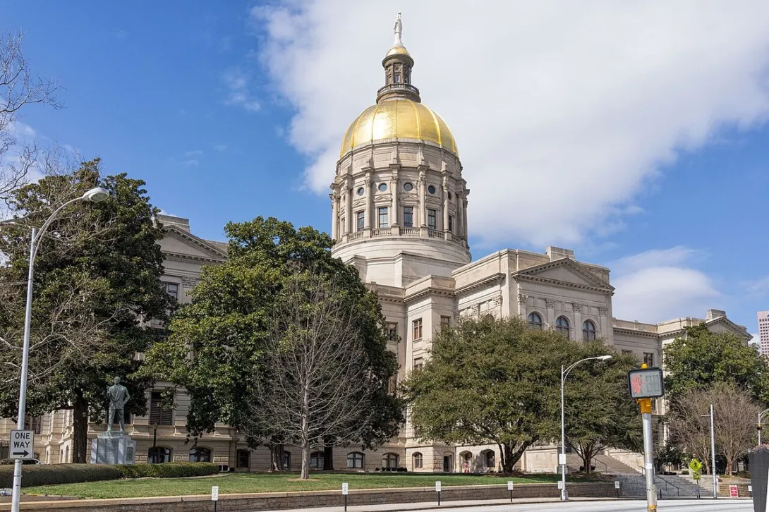 Photograph of the Georgia State Capitol building in Atlanta with its gold dome under a blue sky.