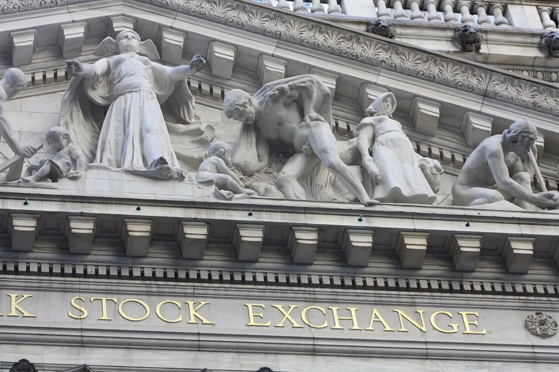Photograph of the carved stone facade of the New York Stock Exchange building with its gold Stock Exchange lettering.